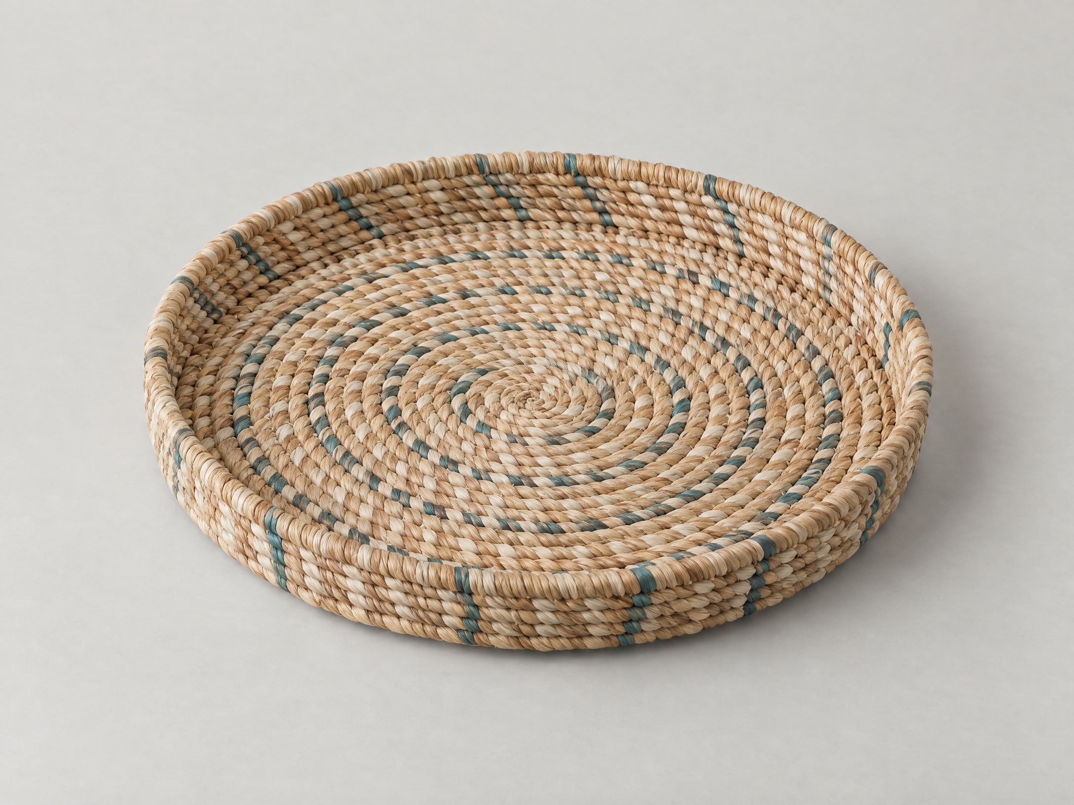 Original AI-generated concept of an empty round woven catchall tray in sand and muted teal